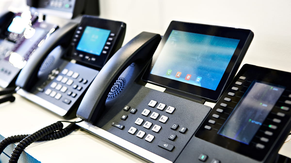 APB Telecom technician setting up VoIP and emergency phone lines